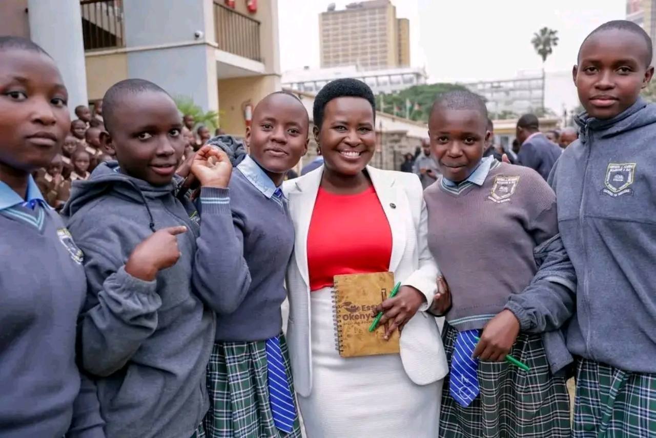 Students posing with Sen. Essy Okenyuri