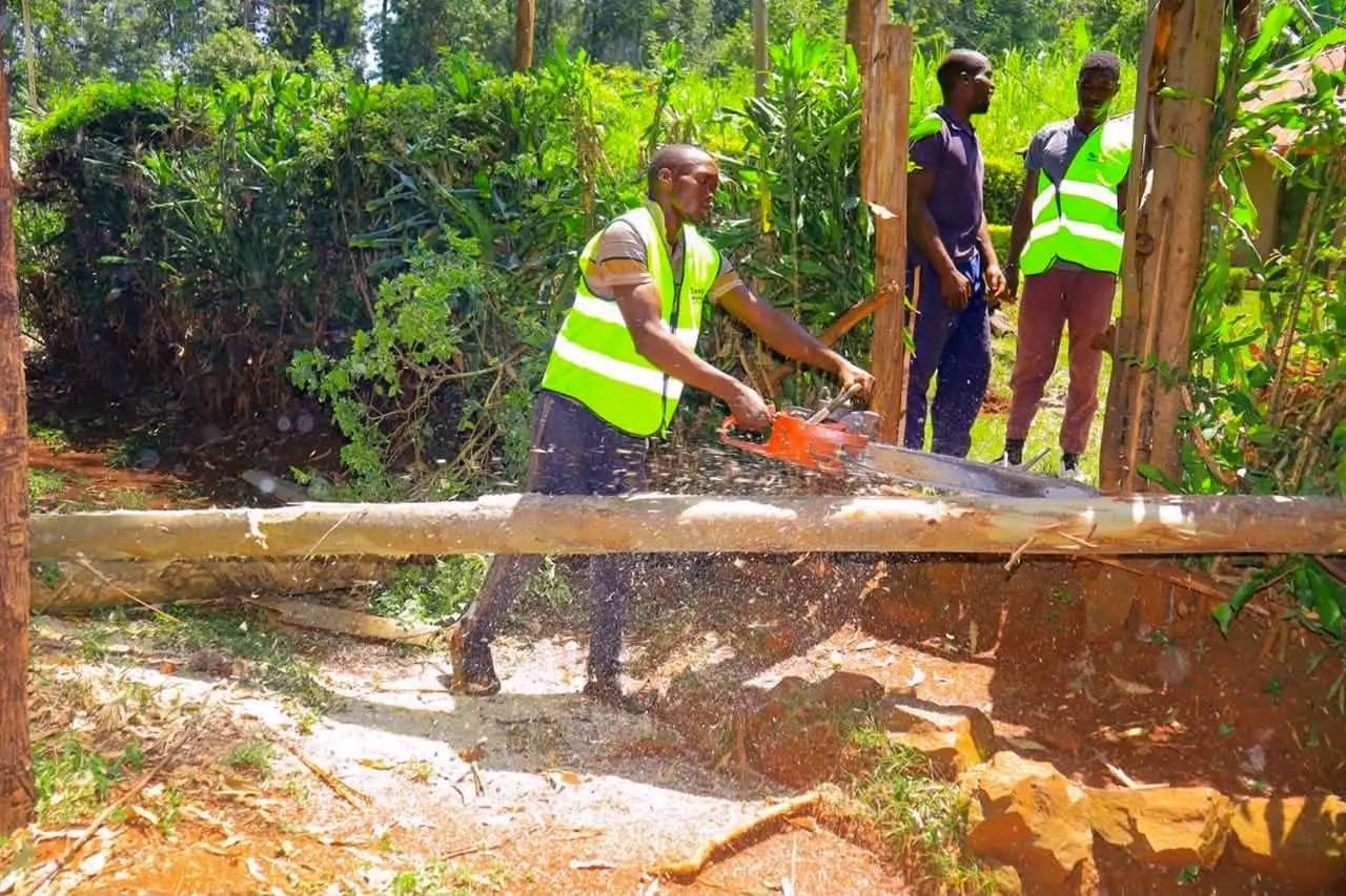 EOF team preparing timber poles for construction